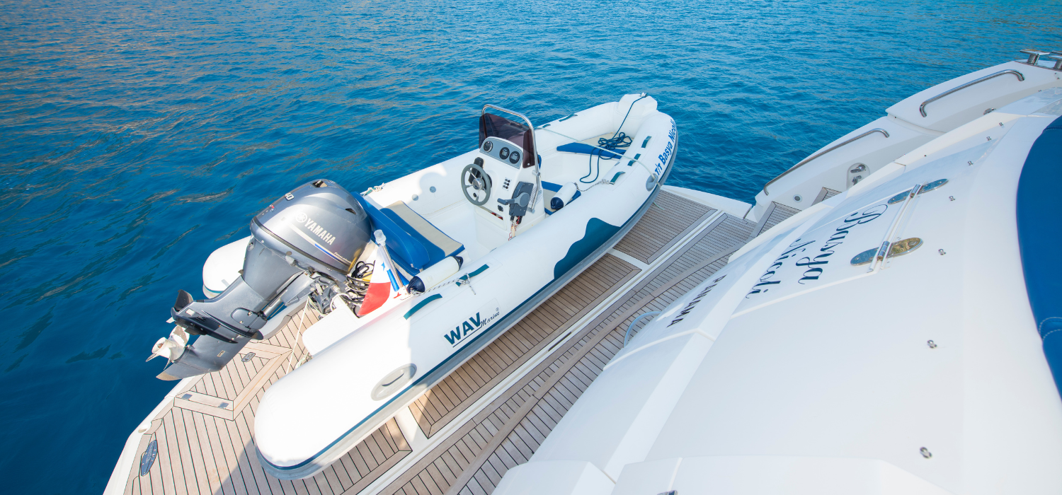 Exterior shot featuring a swim platform and tender with a jetski positioned on top with a crane to lower it down