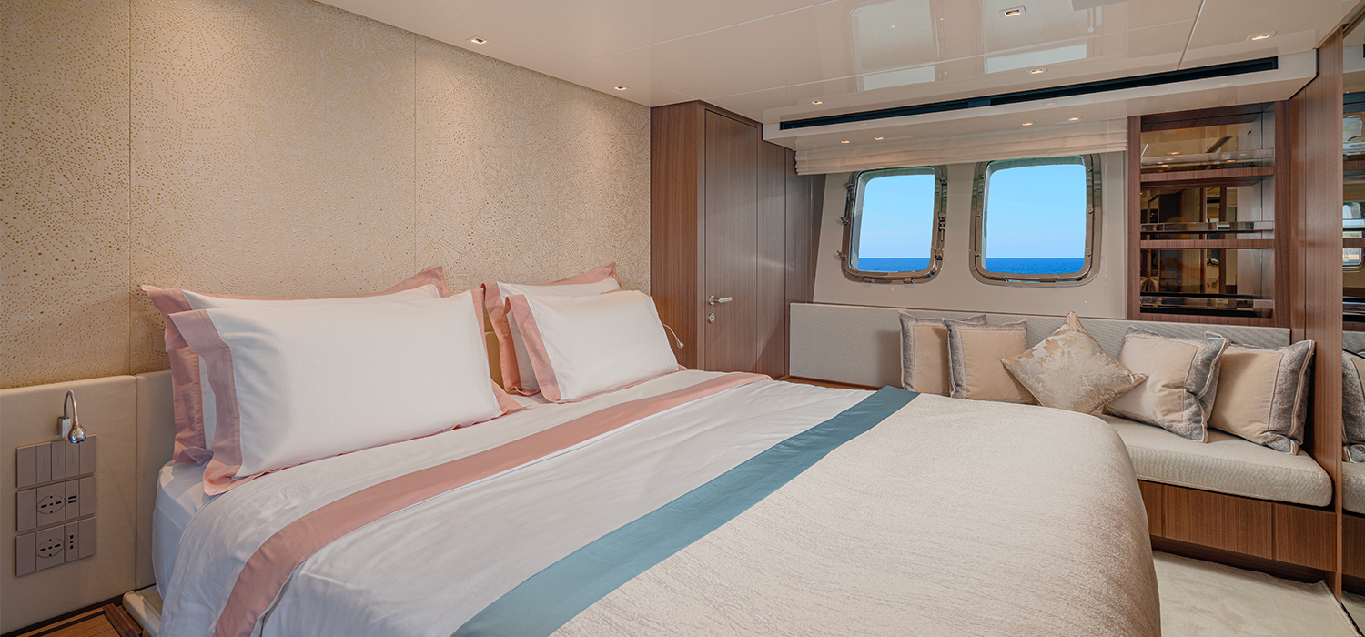 A master cabin with bed on board luxury motor yacht Firefly